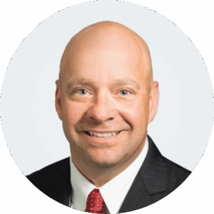 Headshot of a person in a suit.