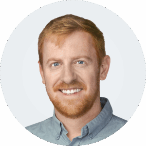 Headshot of a person in a button-up shirt.