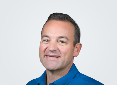 Headshot of Jon Westervelt, a man with brown hair, in front of a light grey background.
