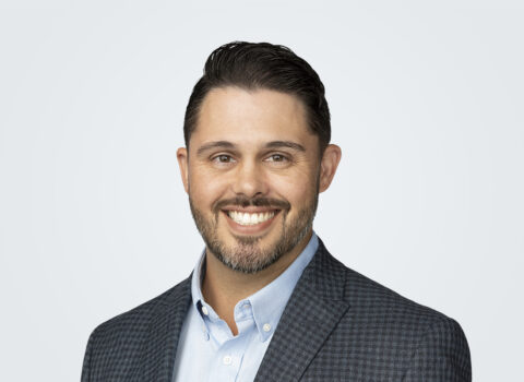 Headshot of Spencer Archer, Design-Build Director, a man with dark brown hair, in front of a light grey background.