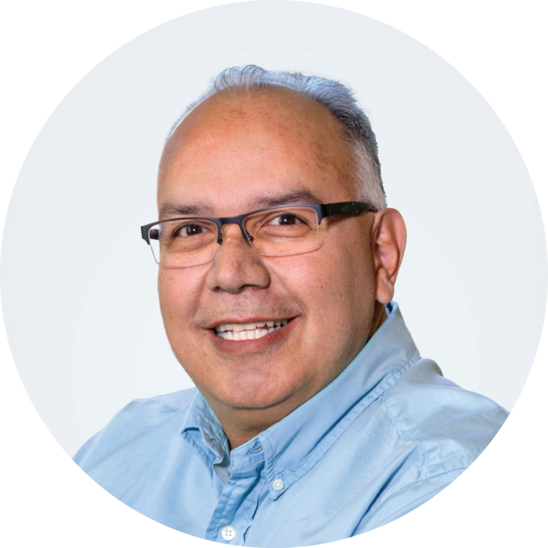 Headshot of Jerry Pena wearing glasses and a blue dress shirt.