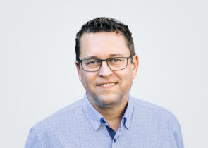 Headshot of a person in a button-down shirt.