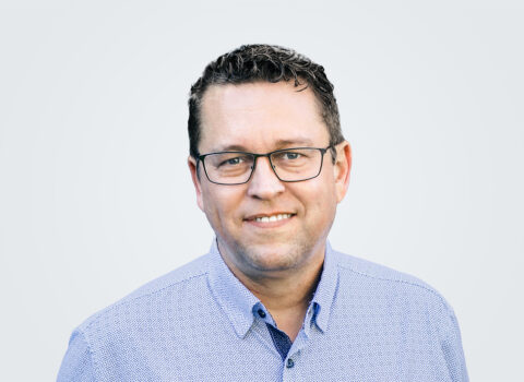 Headshot of a person in a button-down shirt.