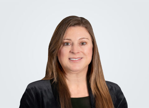 Headshot of Owner Advisor Lead Adrianna Dimperio, a woman with long brown hair, wearing a black blazer.
