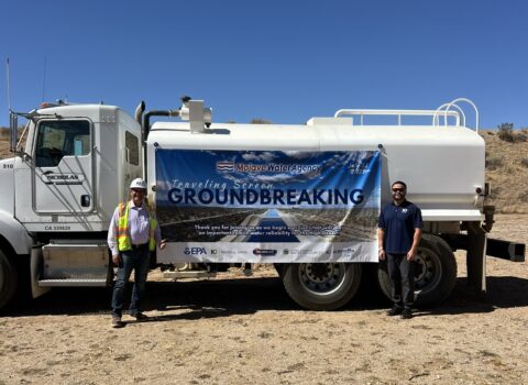 Earl Schwartz and Paul Chau of Kennedy Jenks pose in front of sign announcing groundbreaking for Mojave Water Agency Traveling Screen Project