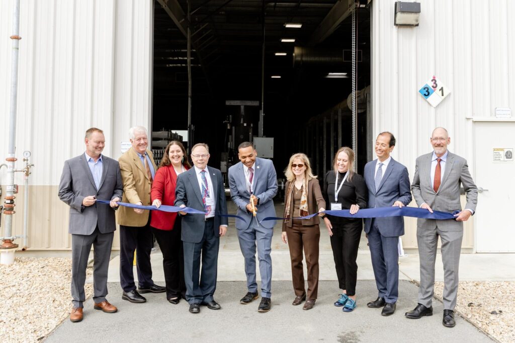 Pure Water Monterey Expansion team cutting the ribbon in front of the facility