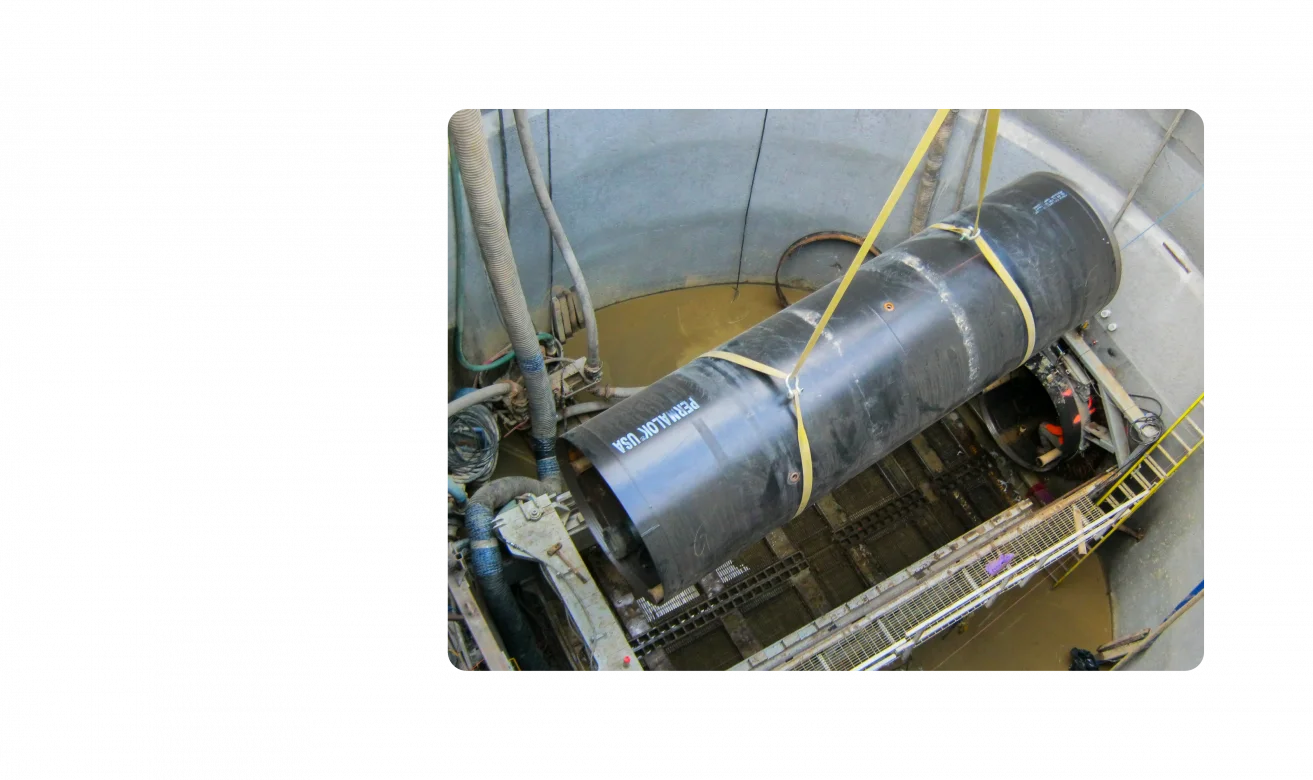 A pipeline installment. Photo is taken at ground level looking down into the ground.