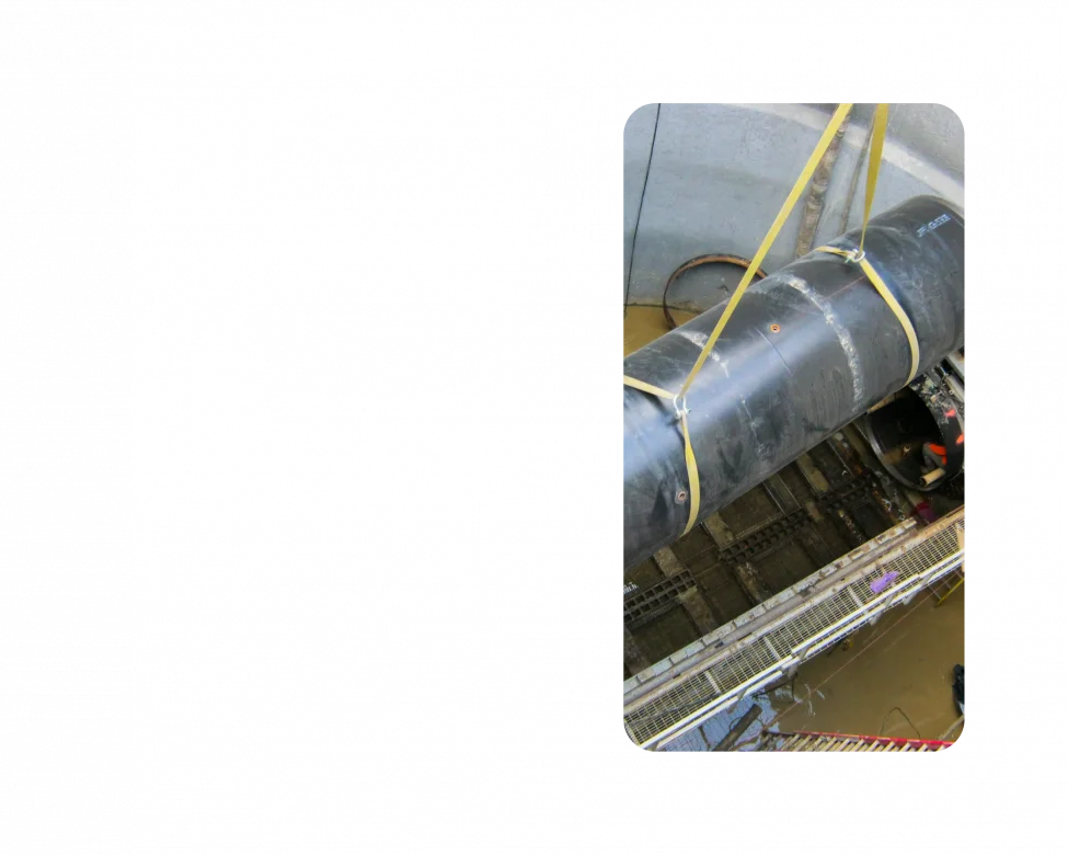 A pipeline installment. Photo is taken at ground level looking down into the ground.